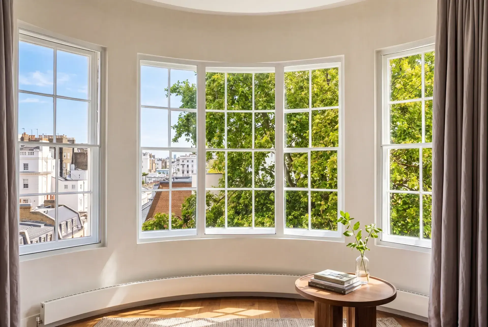 Slimline secondary glazing fitted to a curved Georgian bow window with white glazing bars in a London townhouse