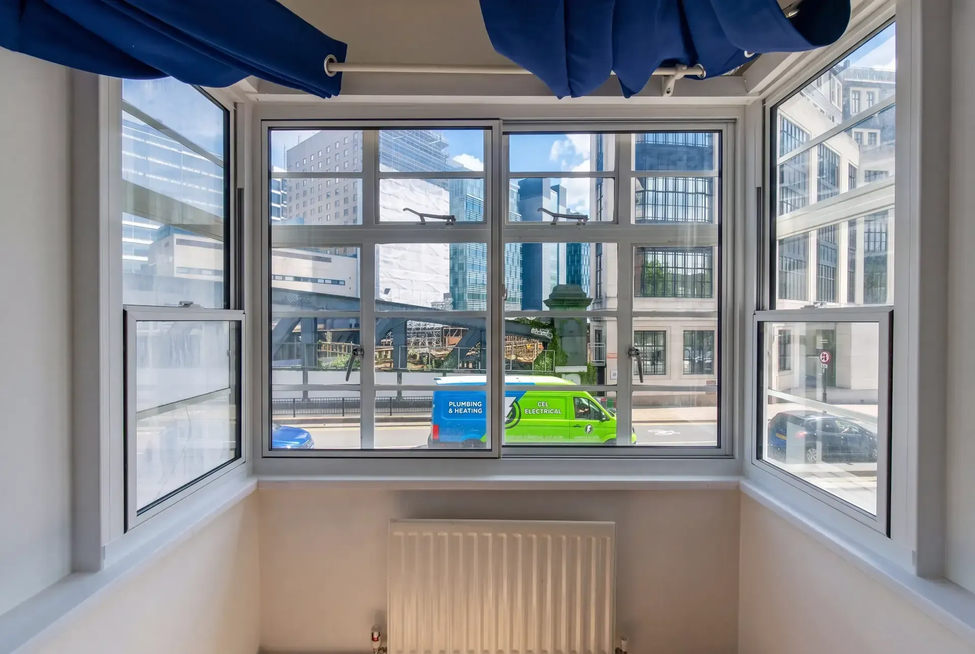 Steel-framed corner bay window fitted with secondary glazing overlooking a busy City road