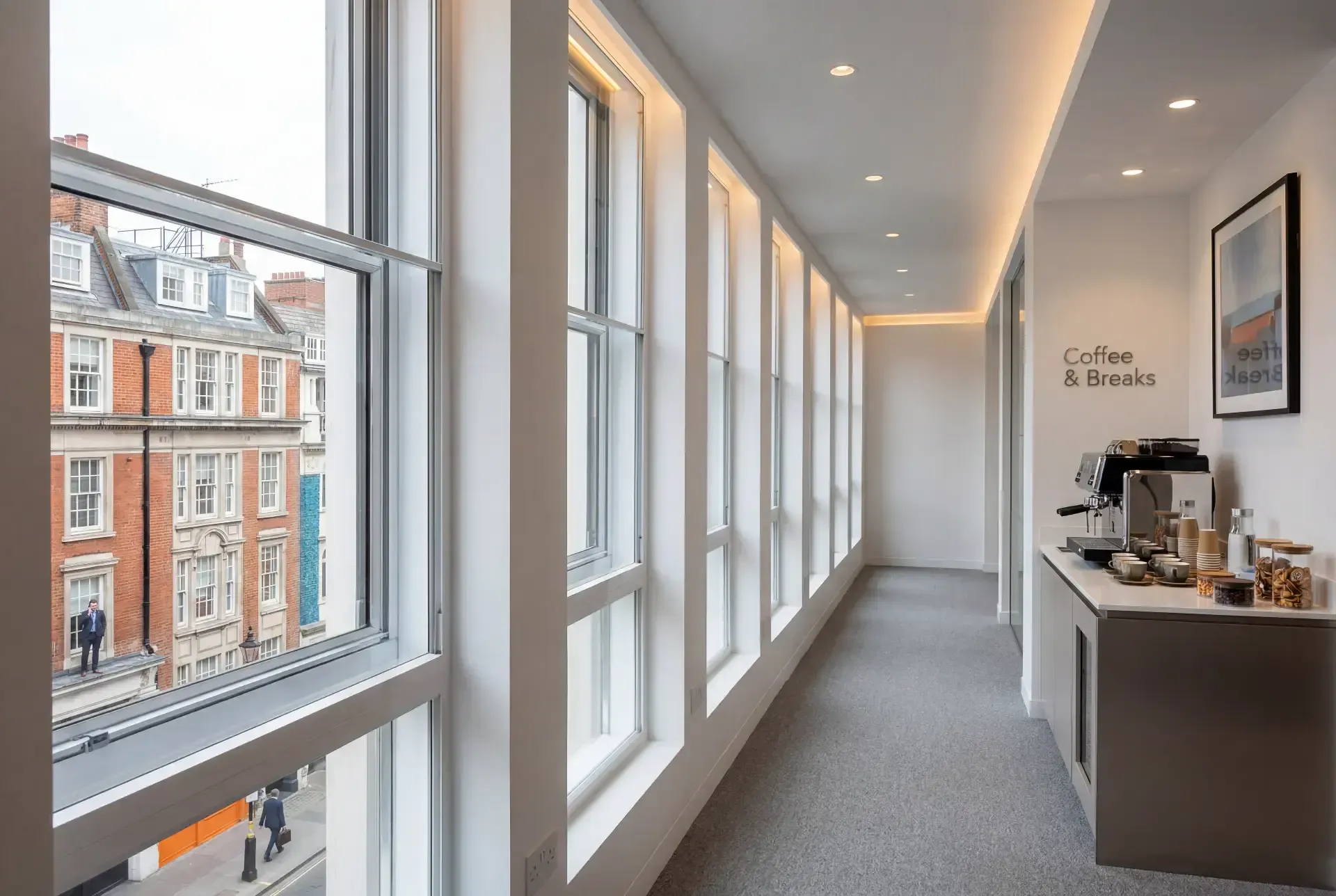 Long run of office sash windows fitted with slimline secondary glazing along a Mayfair corridor