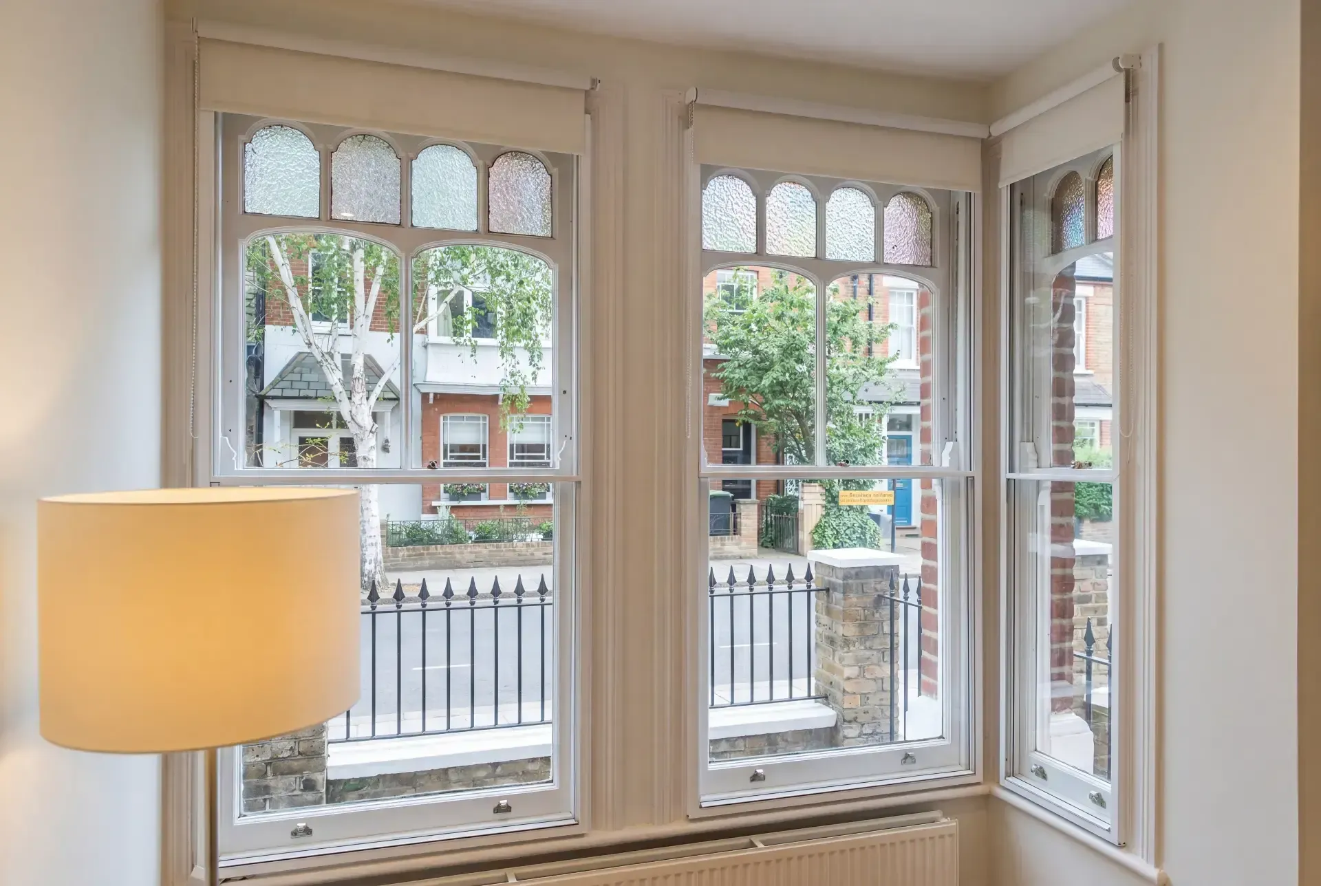 Edwardian bay with stained glass toplights fitted with secondary glazing in a London front room