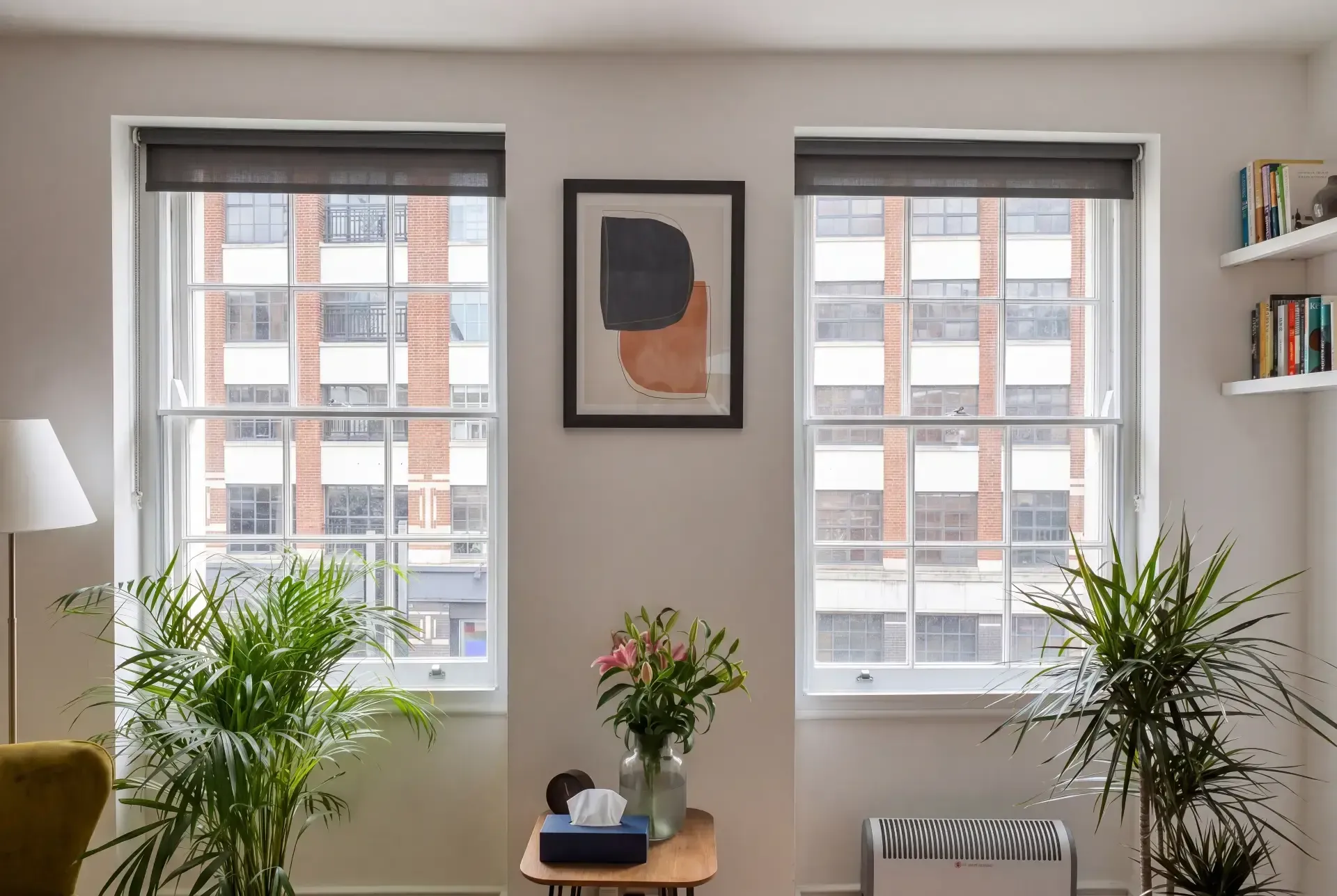 Two tall sash windows with secondary glazing and blackout roller blinds in a City apartment living room