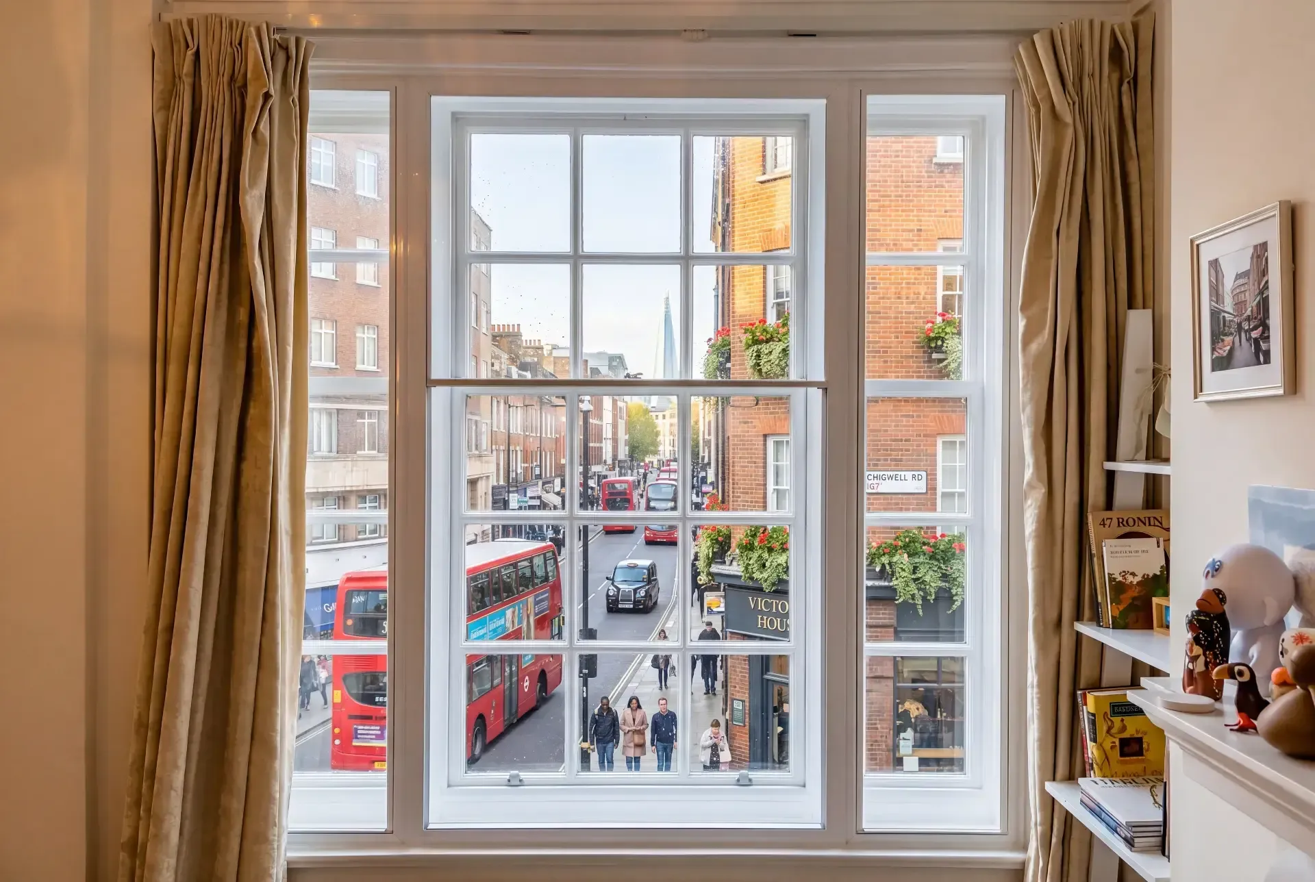 Georgian-bar sash window with secondary glazing overlooking a busy London bus route